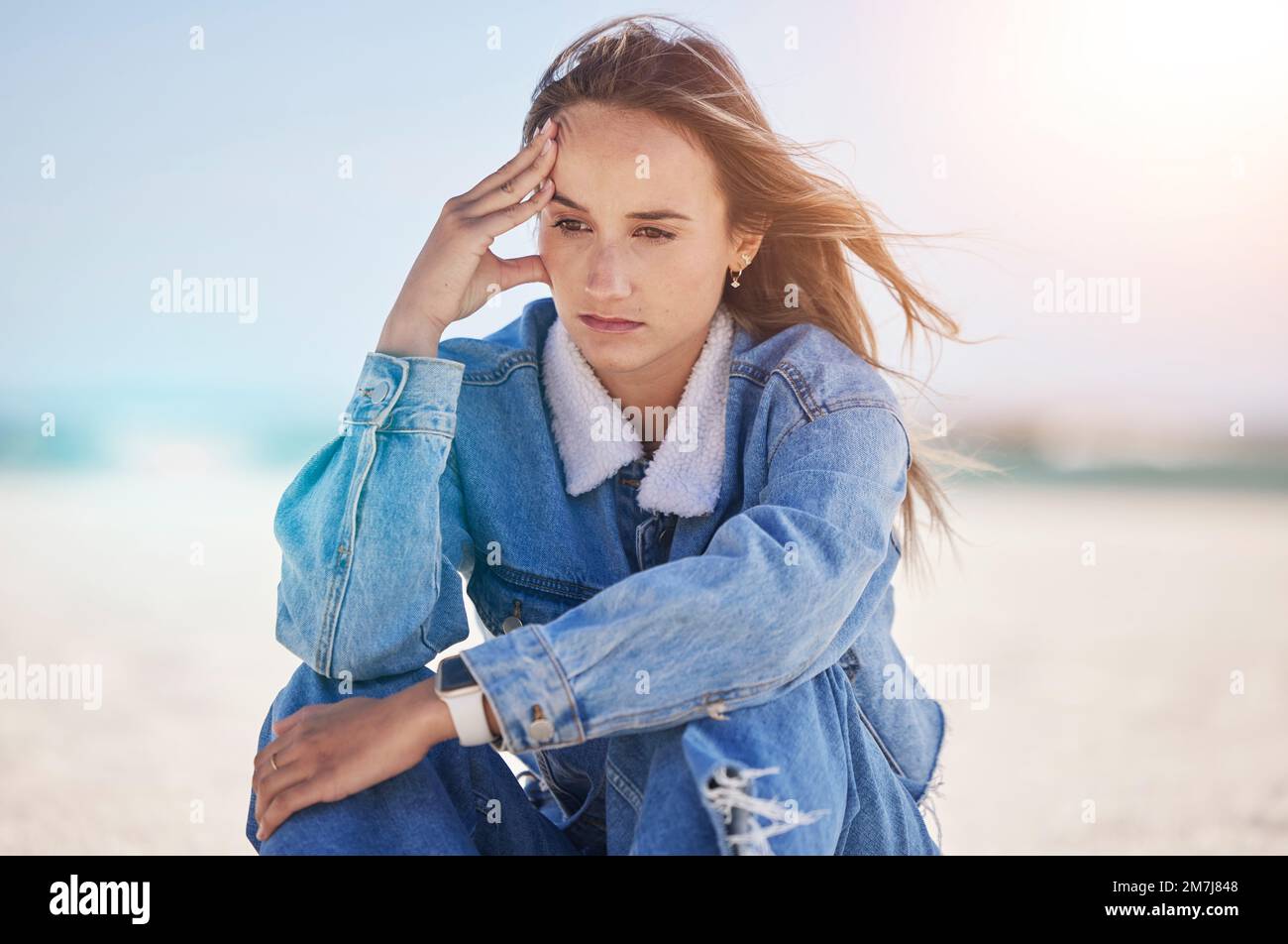 Thinking woman, stress or depression by beach, ocean environment or sea nature and climate change ideas, vision or innovation. Mental health, anxiety Stock Photo