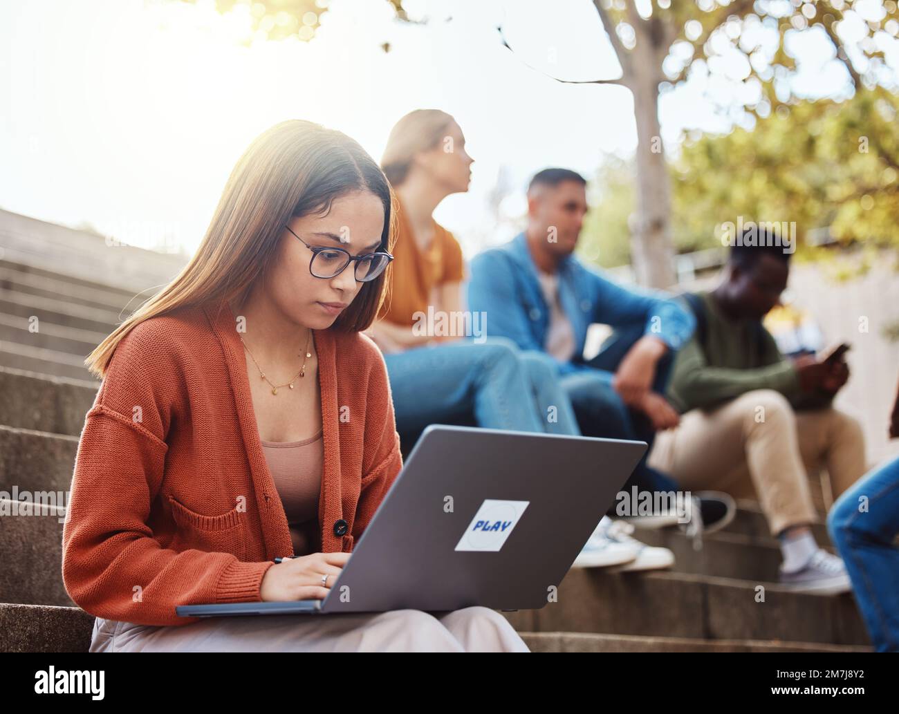 University, woman sitting stairs and laptop research for school project with focus and motivation for education. College, scholarship and student on Stock Photo