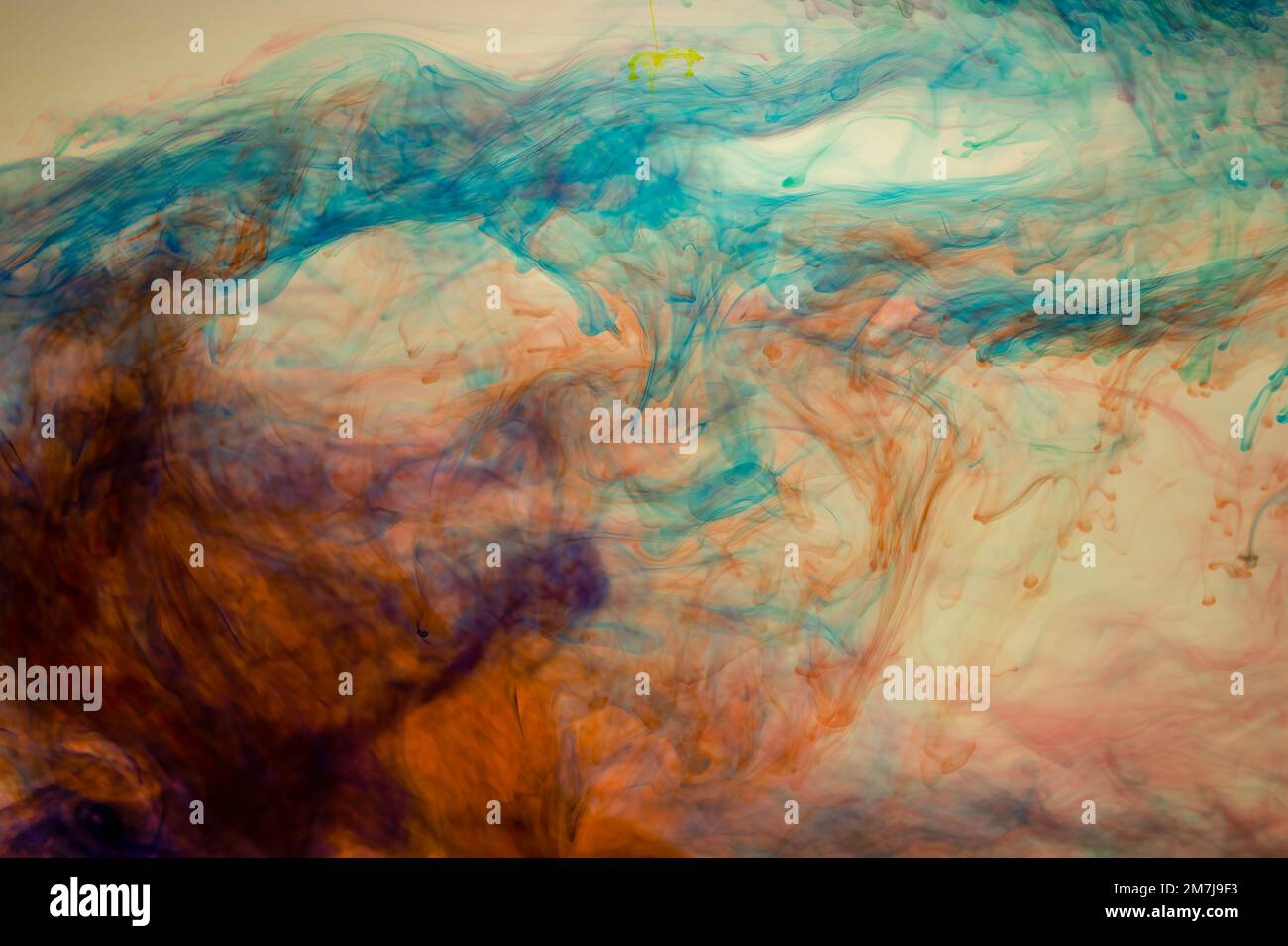 Food colouring swirling through water creating abstract patterns Stock Photo