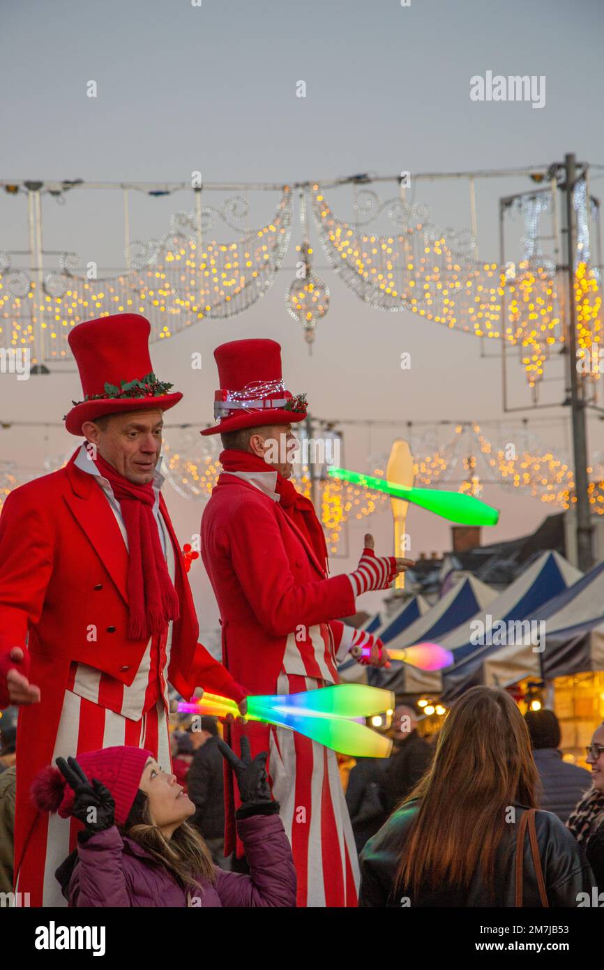 Street performer's stilt walking jugglers at the Stratford on Avon Christmas Street market