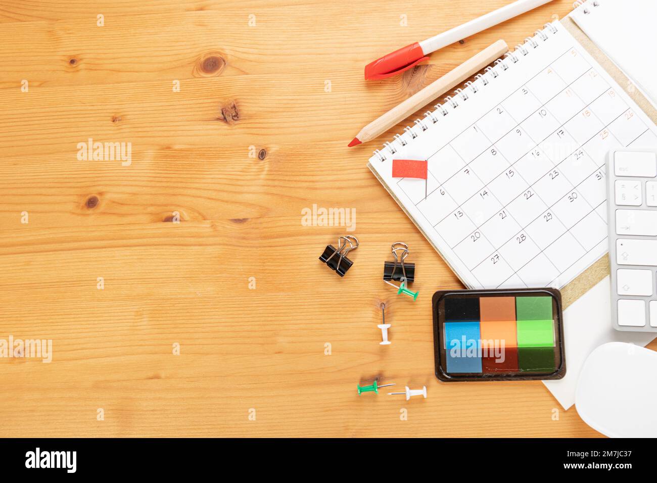 Calendar and agenda reminders, work from home online. desktop calendar with  stationery and pen pencil, keyboard. mark a holiday trip or plans in a dia  Stock Photo - Alamy