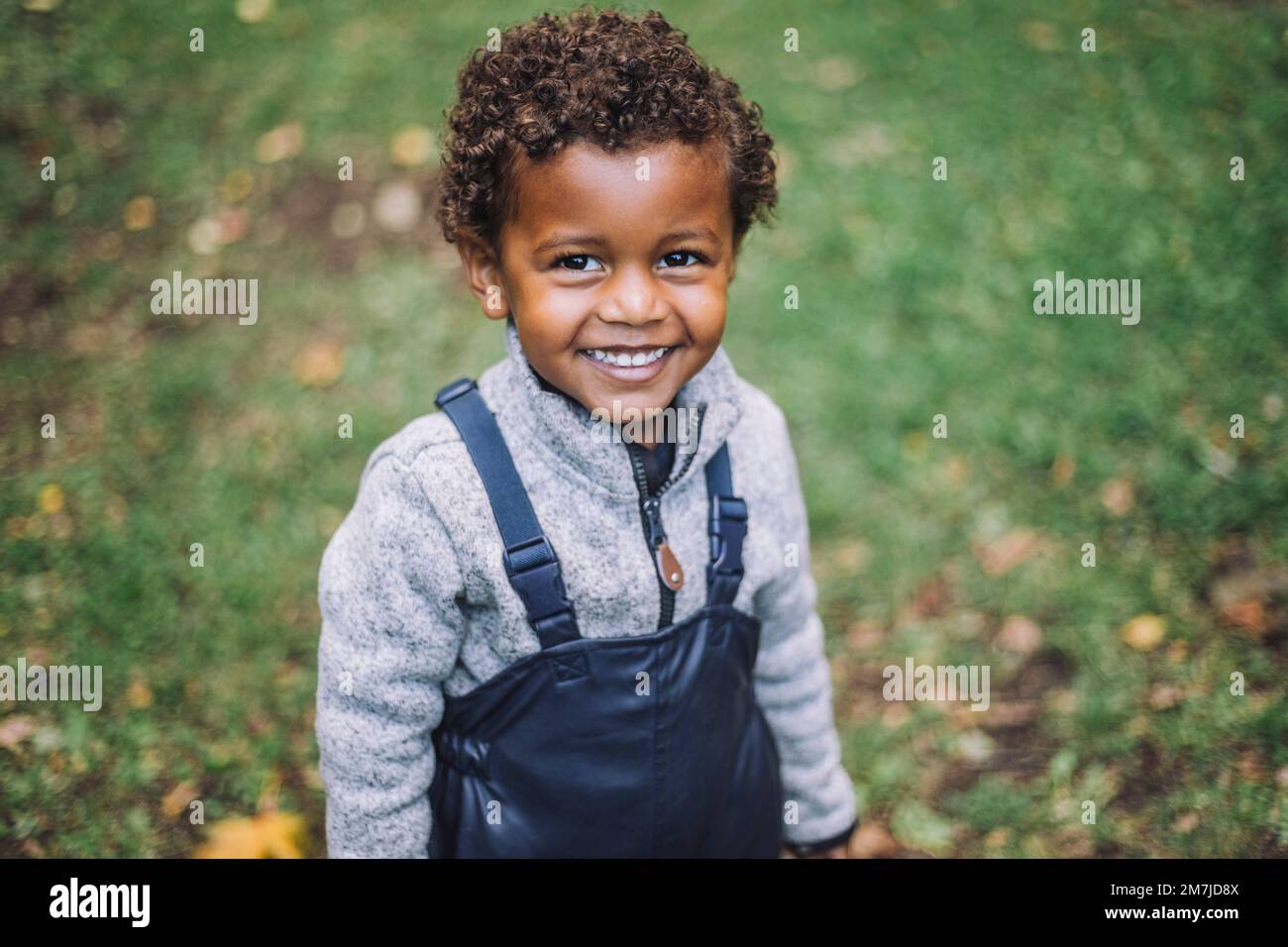 Portrait of smiling boy standing in park Stock Photo
