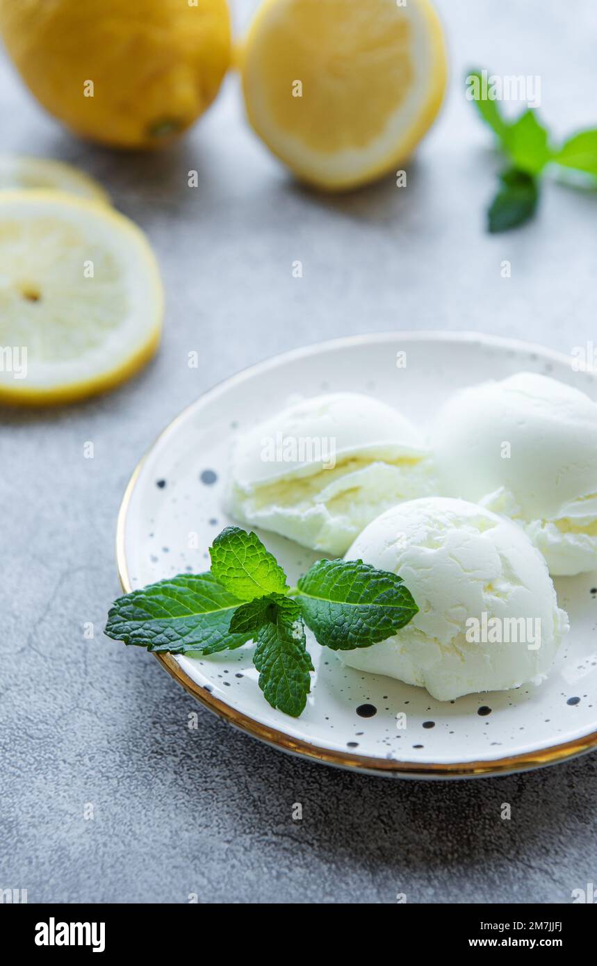 Homemade citrus lemon ice cream with mint on plate Stock Photo