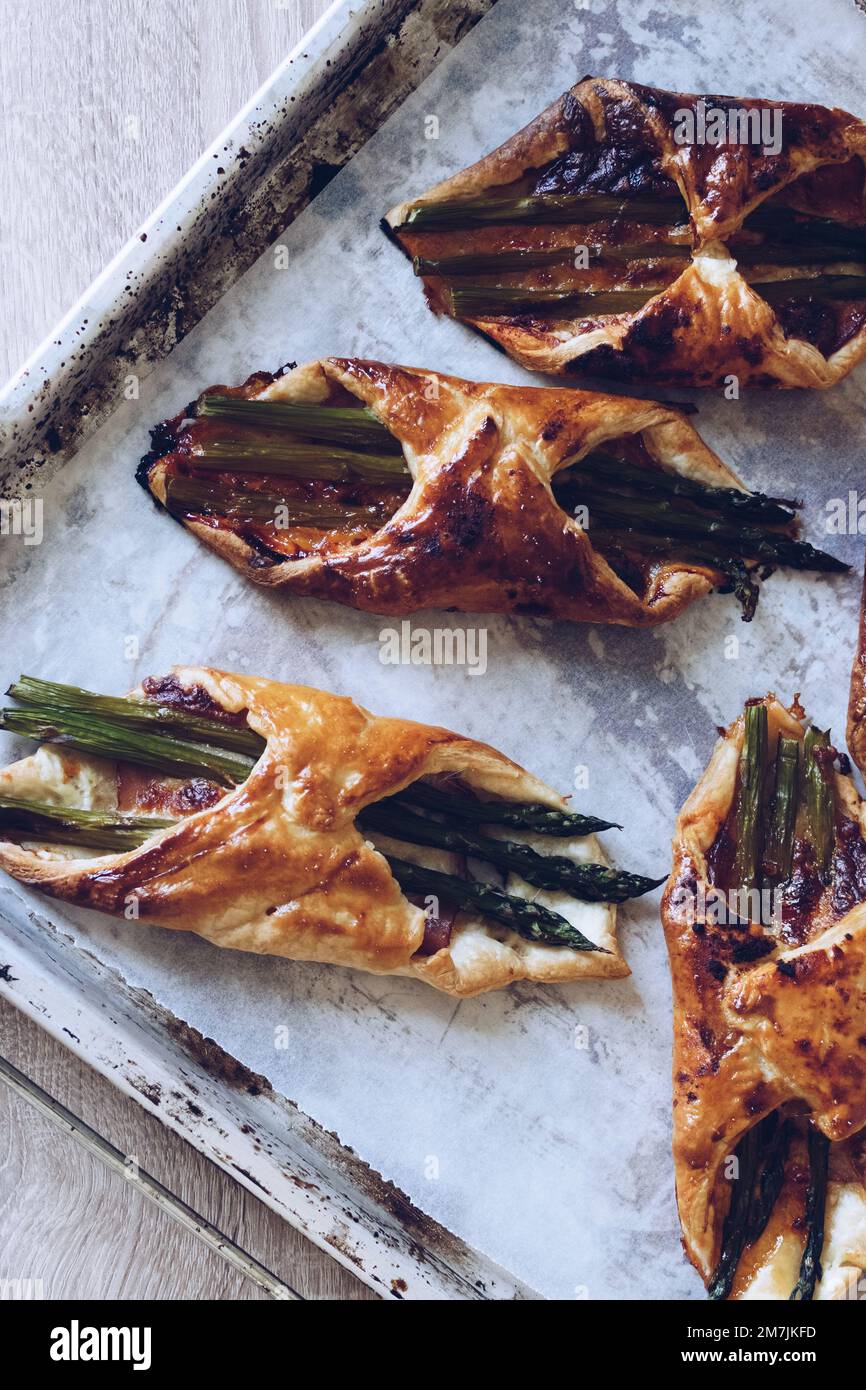 Asparagus baked in puff pastry with ham and cheese Stock Photo Alamy