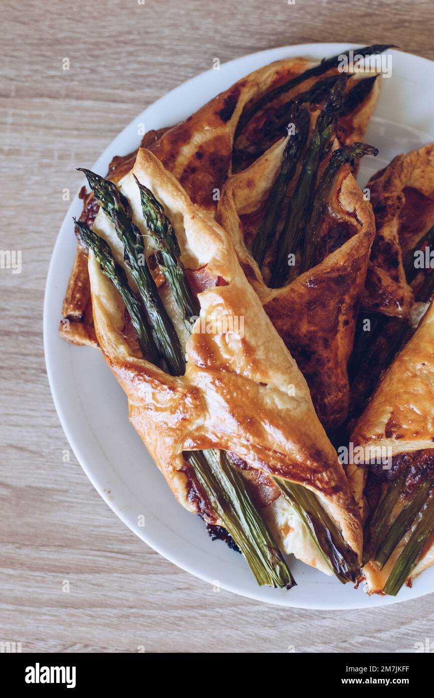 Asparagus baked in puff pastry with ham and cheese Stock Photo Alamy