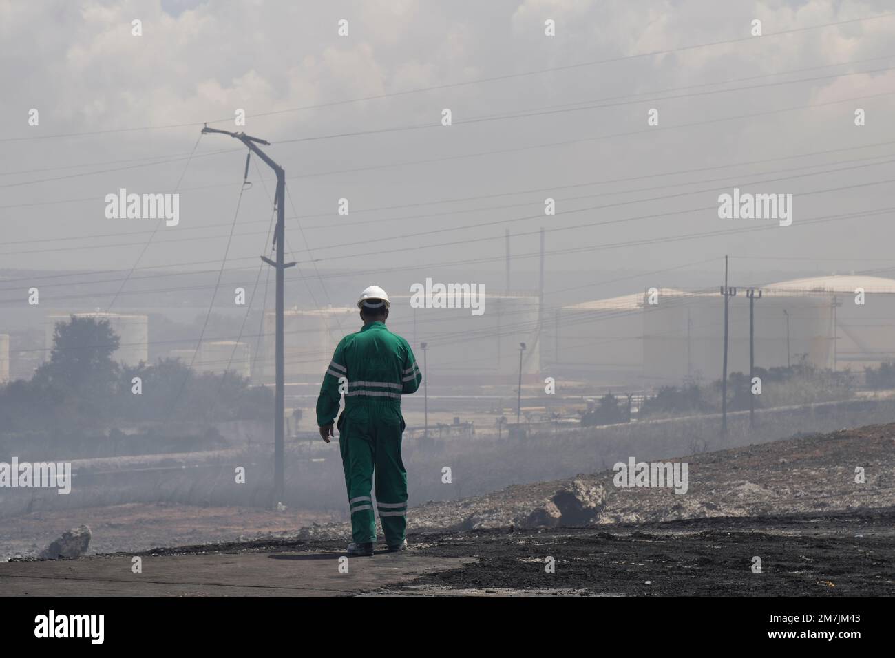 A man standing in the support staff area devastated by a major fire Stock Photo
