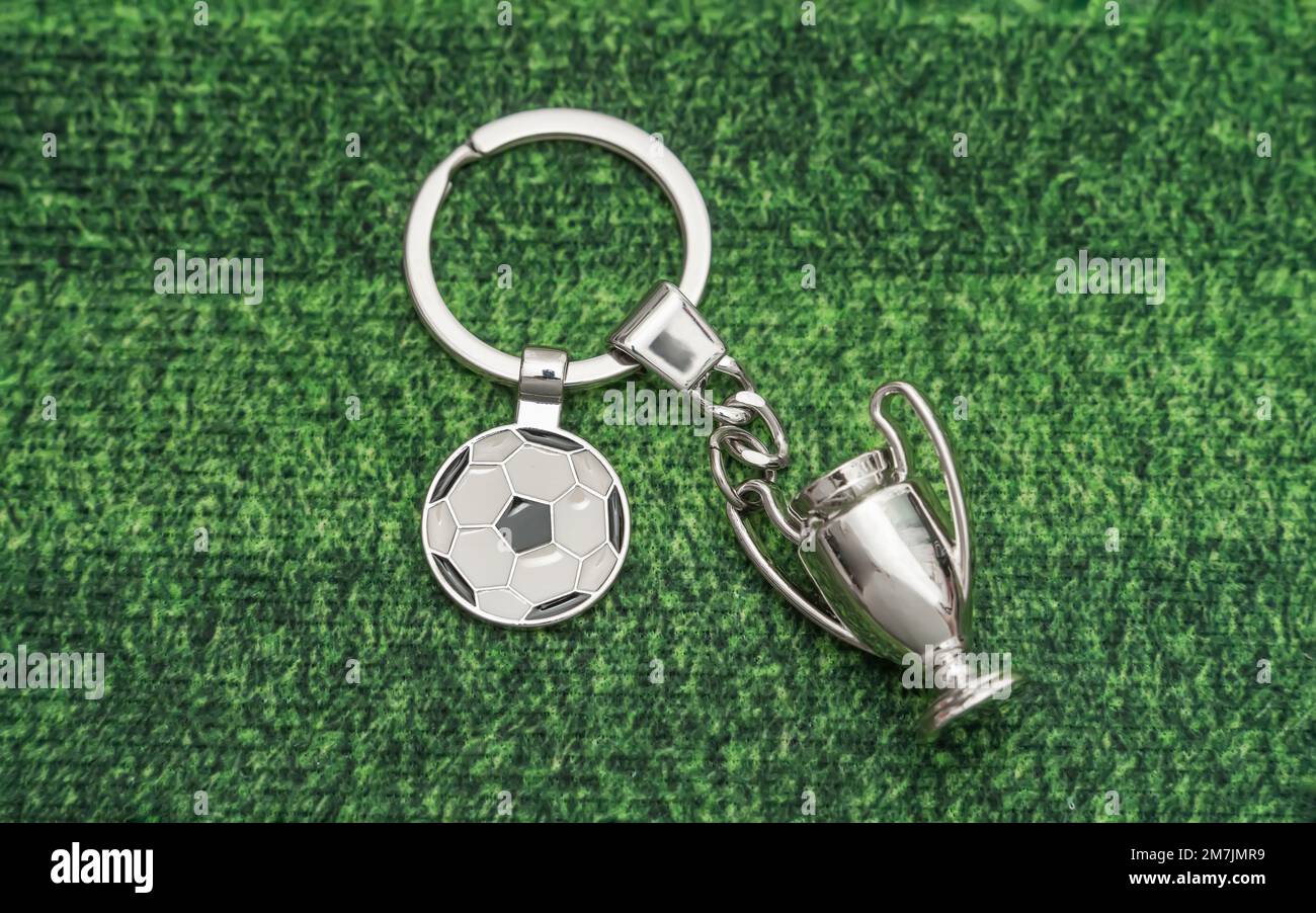 Keychain with a soccer ball shape on green background Stock Photo
