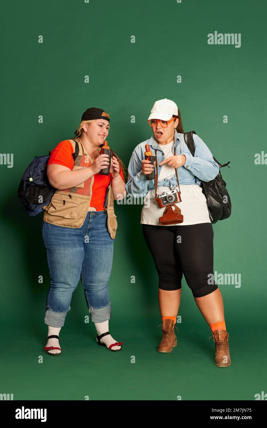 Portrait of two overweight women, friends in casual clothes with