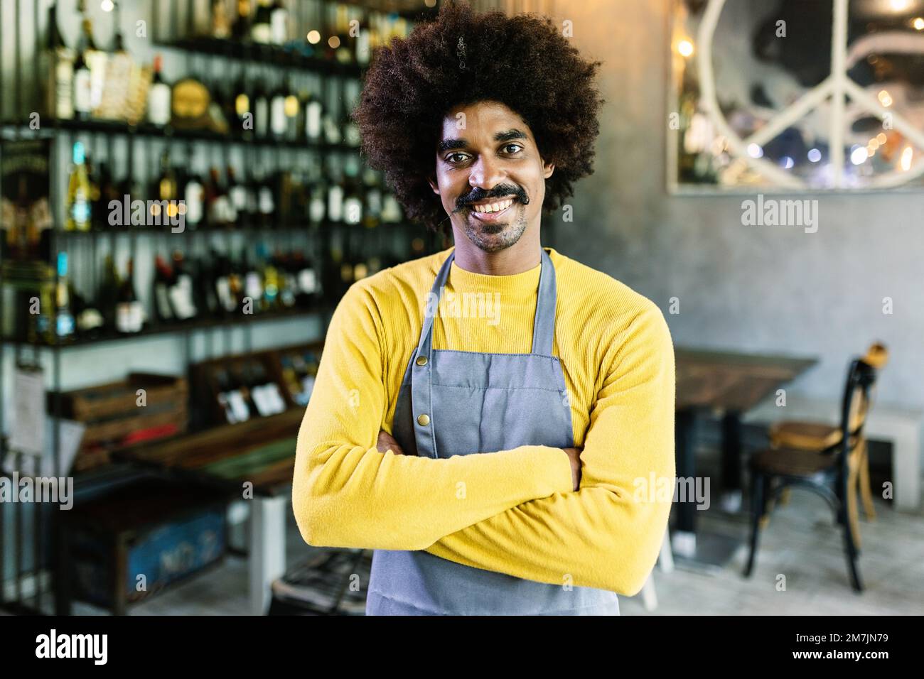 Small business african american owner with arms crossed smiling at camera Stock Photo