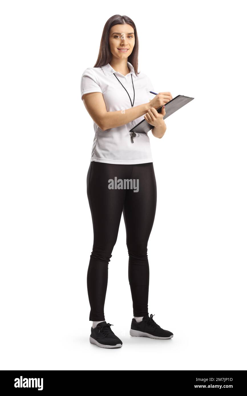 Full length portrait of a female sport coach holding a clipboard and smiling at camera isolated on white background Stock Photo
