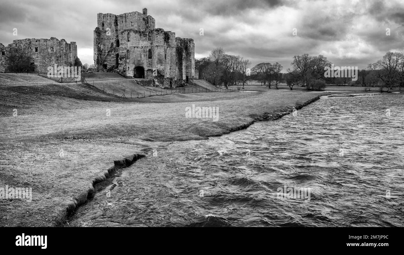 Historic Brougham Castle standing above the flooding and fast flowing