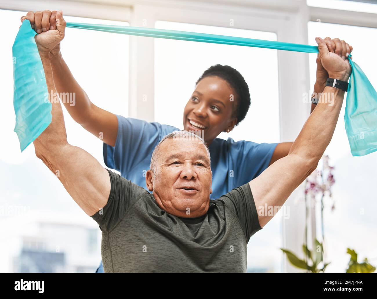 Physiotherapy help, stretching band and doctor with senior man in physical therapy, rehabilitation or healthcare support. Black woman chiropractor or Stock Photo