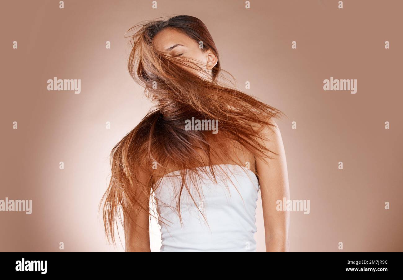 Hair care, beauty and cosmetics of a woman shaking her head on studio  background for luxury keratin treatment. Headshot of aesthetic model posing  for Stock Photo - Alamy