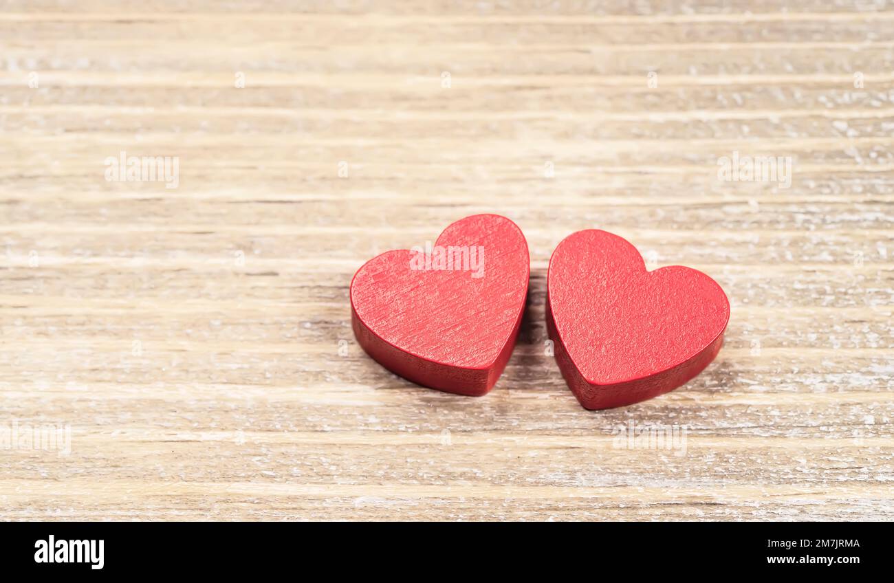 Two red handmade wooden carved hearts on wood background,couple relationship Valentine day concept Stock Photo