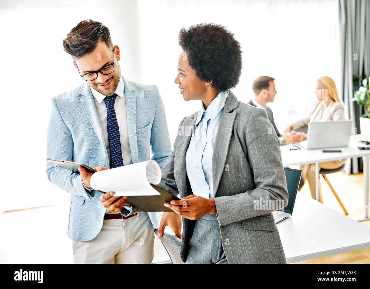 young business people meeting office teamwork group success corporate discussion tablet document Stock Photo