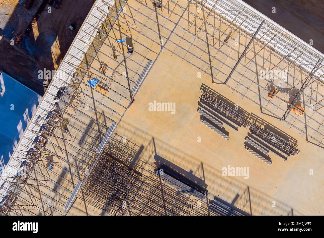 There building site where metal frame steel framework for warehouse roof truss is under construction Stock Photo