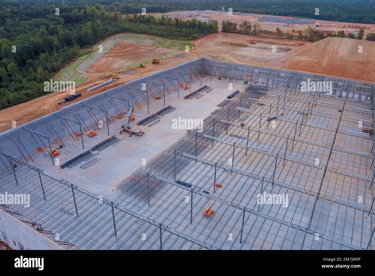 Warehouse roof truss metal frame steel framework in building site that is under construction Stock Photo