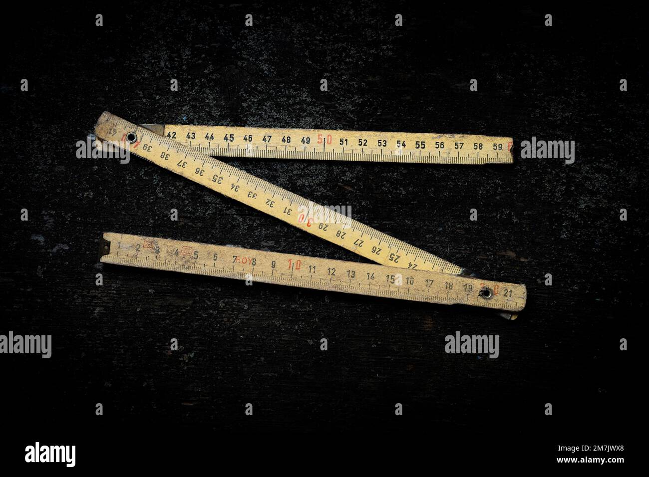 Top view of the zigzag folding rule isolated on the empty black background Stock Photo