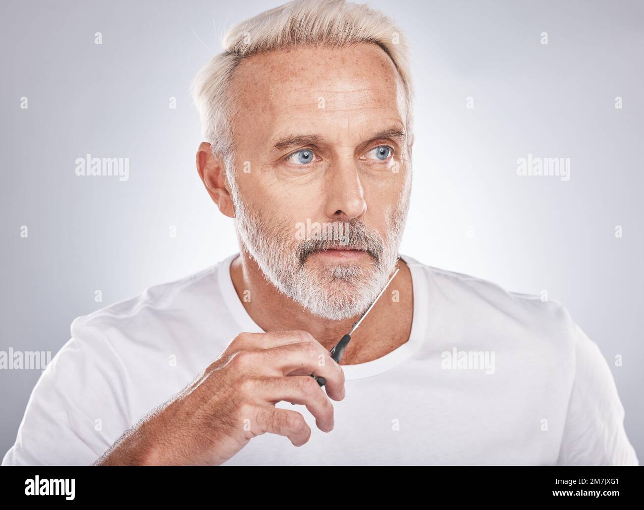 Scissors, wellness and man cutting beard on face for morning routine