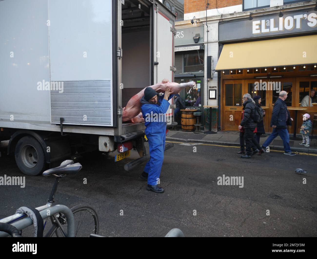 Butcher carrying a dead pig hires stock photography and images Alamy