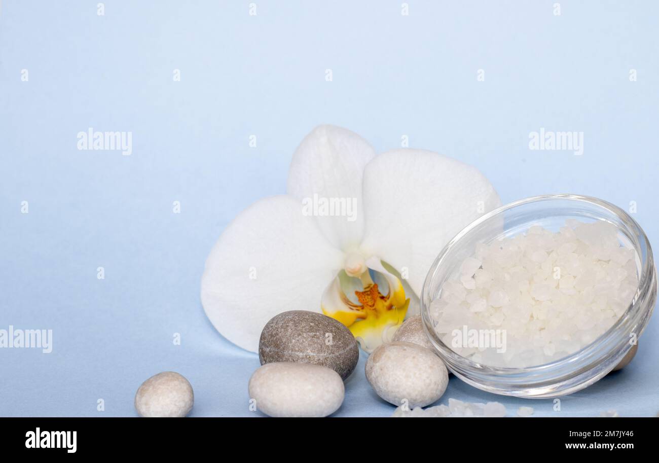 spa wellness concept.pebbles rocks in pyramid sea salt and orchid