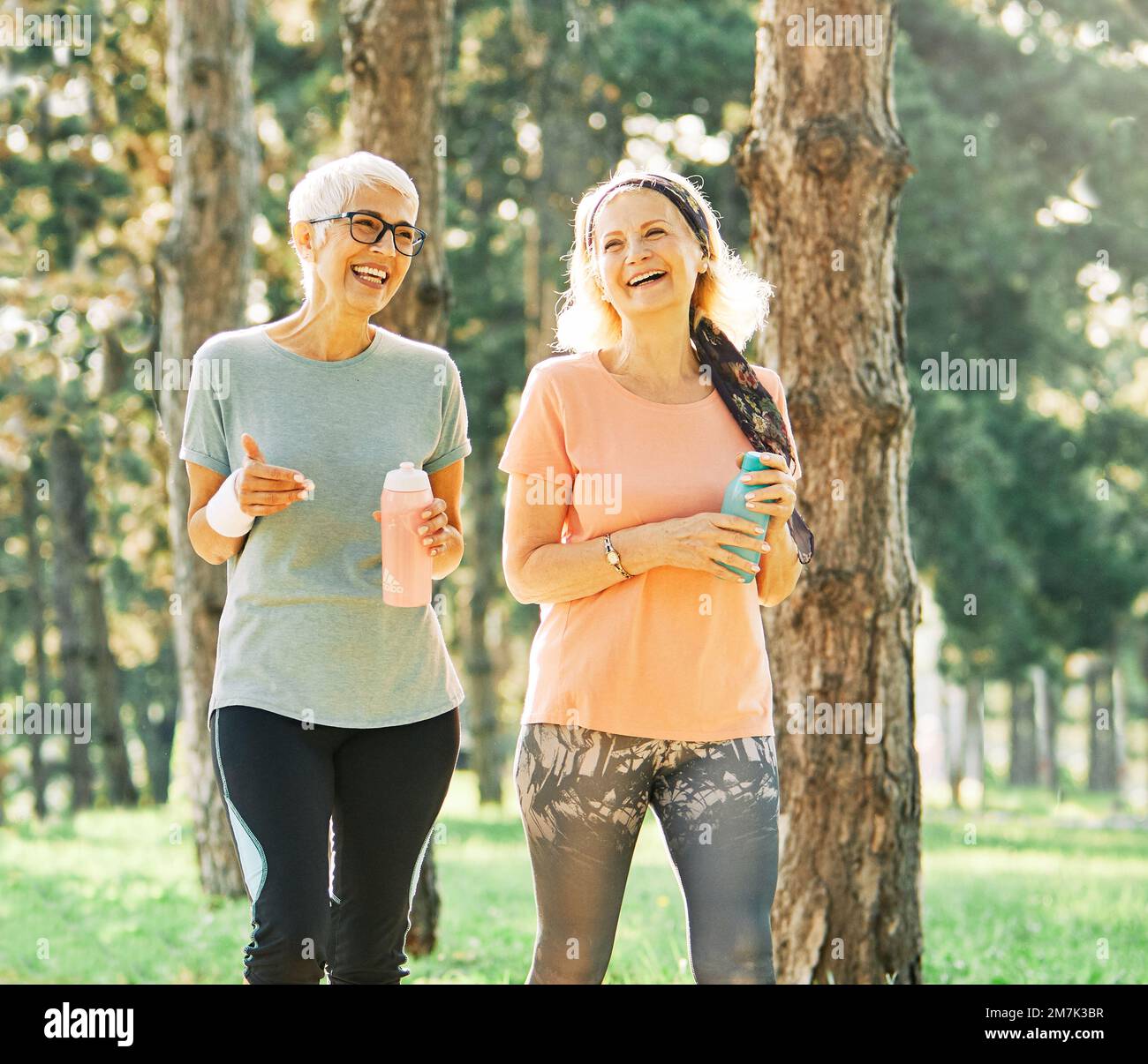 outdoor senior fitness woman man lifestyle active sport exercise healthy fit runner running jogging elderly mature gray hair Stock Photo