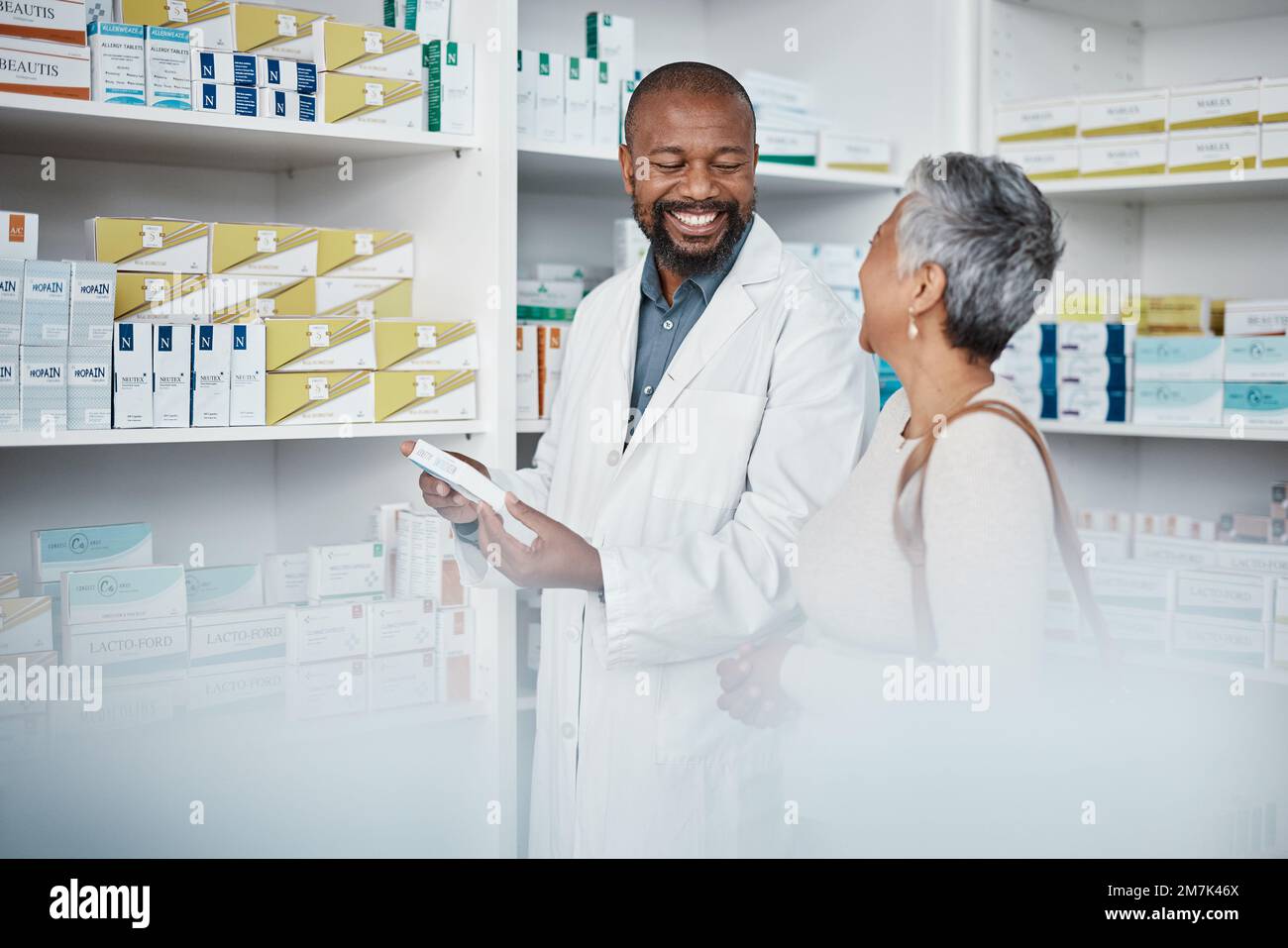 Pharmacy, medicine and senior woman consulting pharmacist on