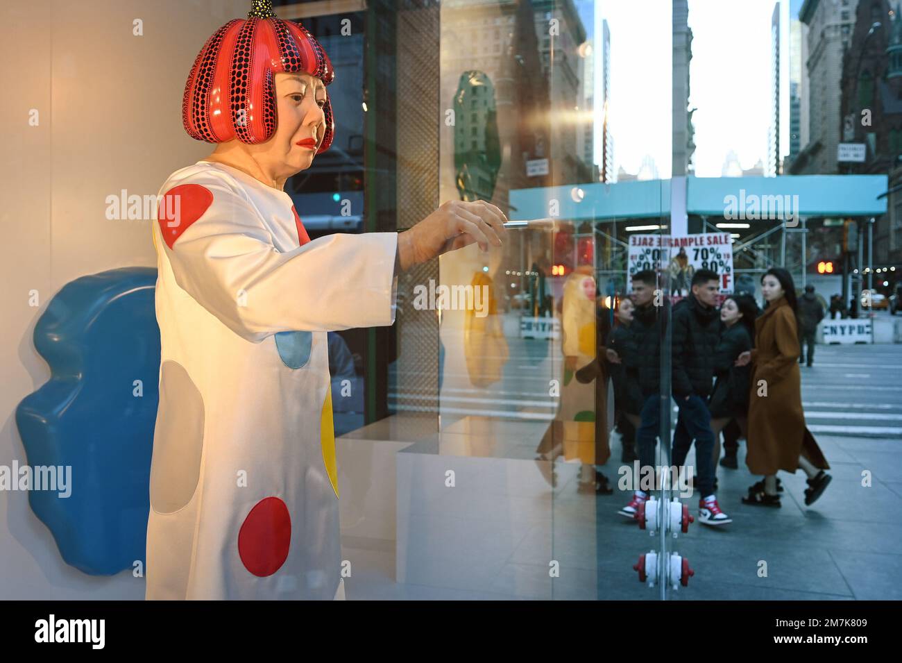 View of the Yayoi Kusama robot painting spots on the window of the