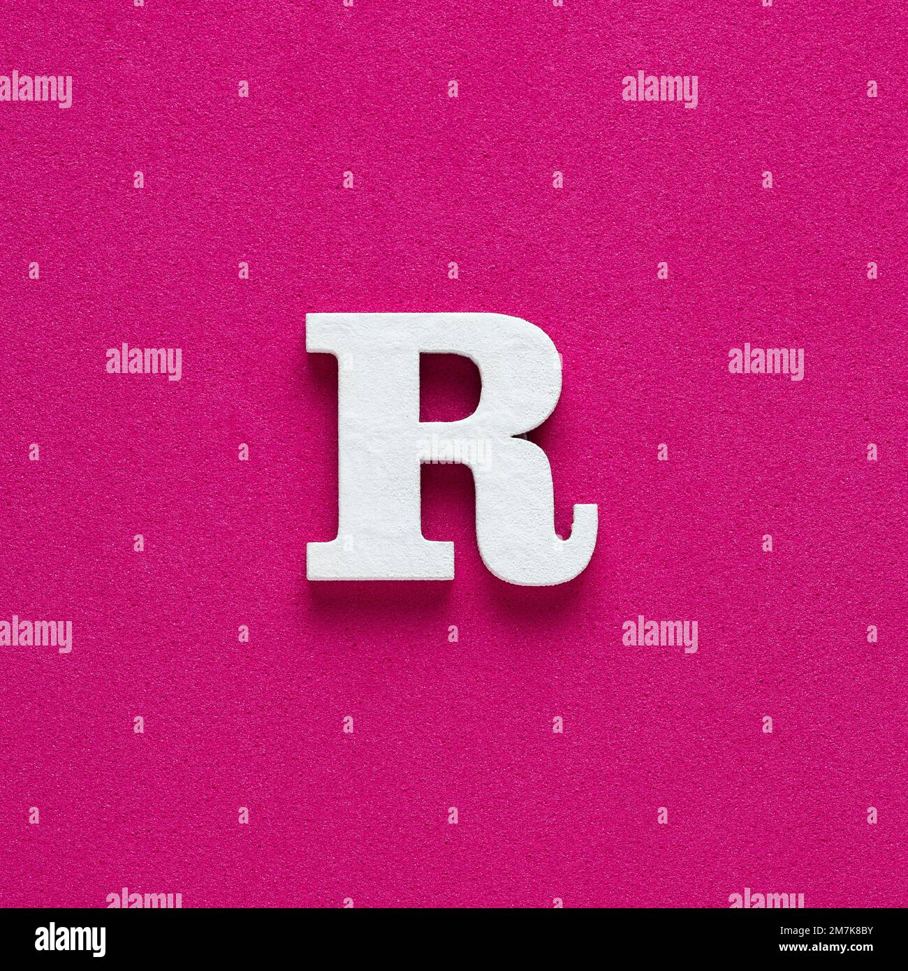Letter R uppercase - White wood font on rhodamine red background Stock ...