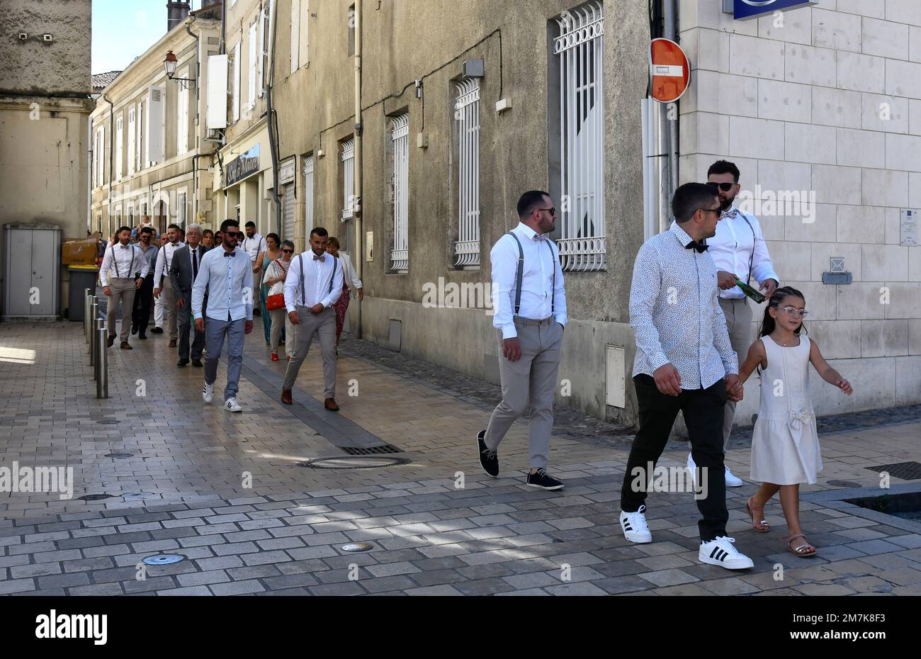 Wedding guests walking to the the church at Condom in the Lot-et-Garonne department, Southwestern France Stock Photo