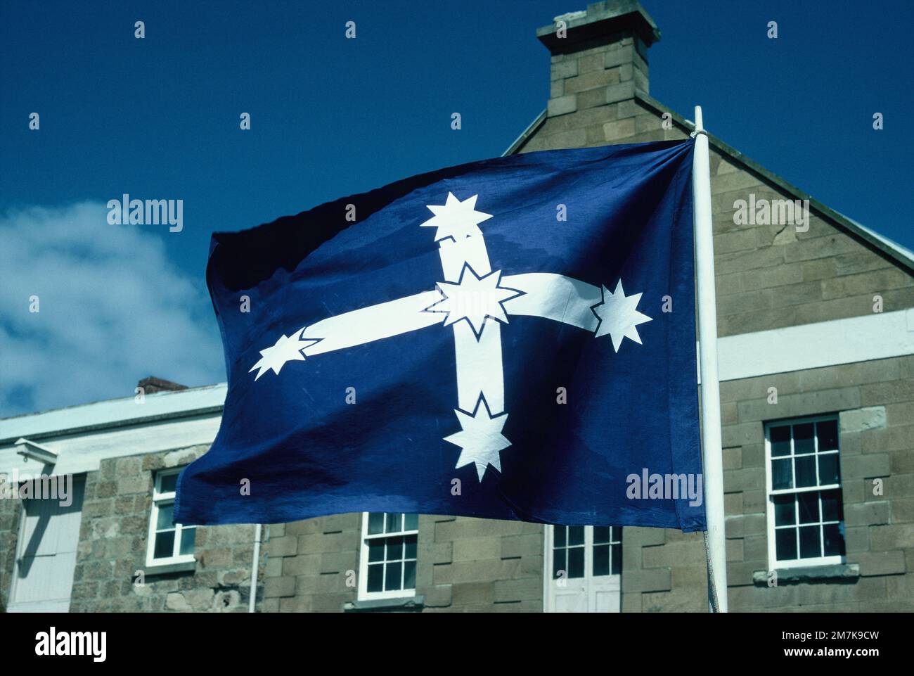 Australian Federation Eureka flag flying in front of old building. Stock Photo