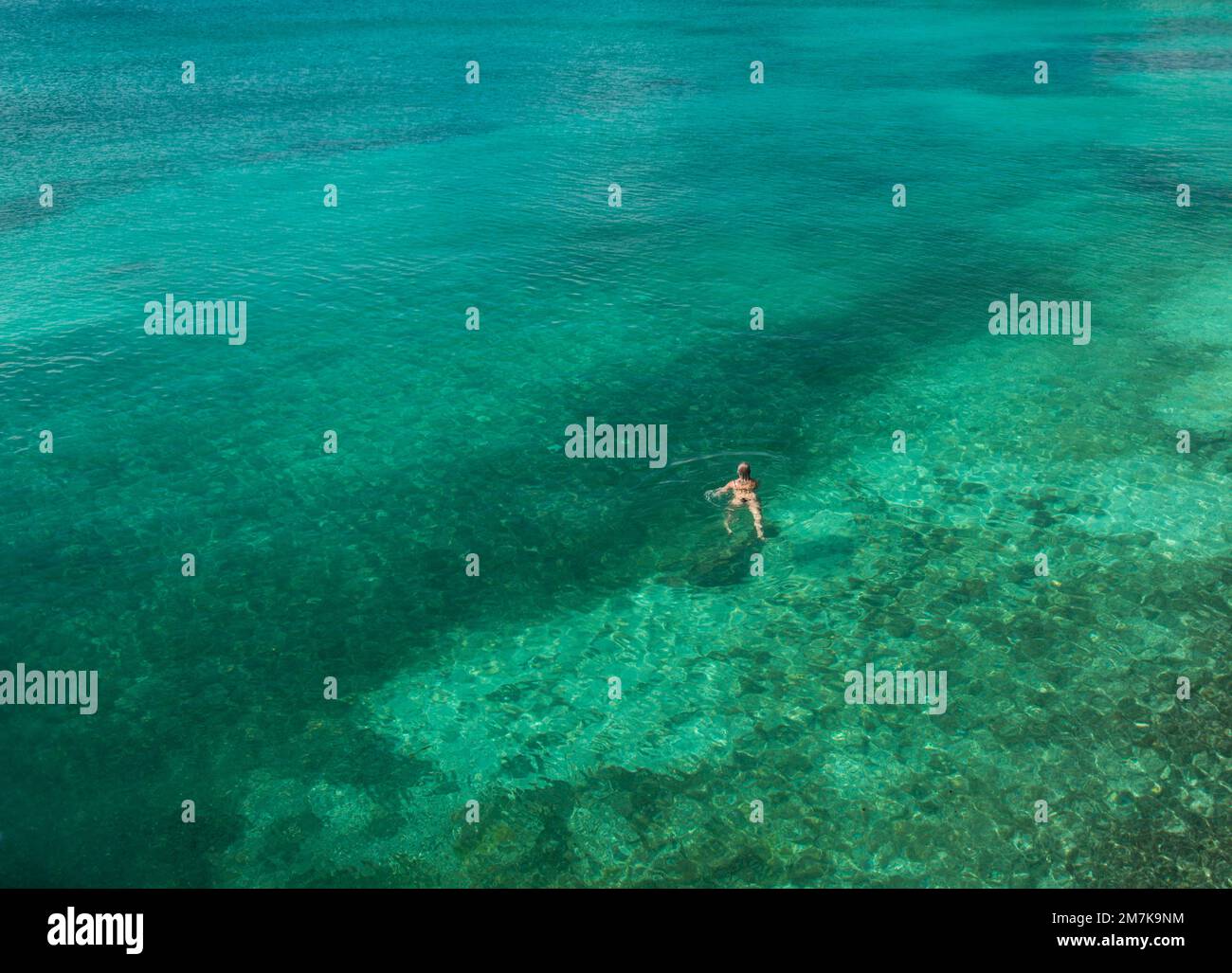 Woman is swimming at the Bahamas Stock Photo