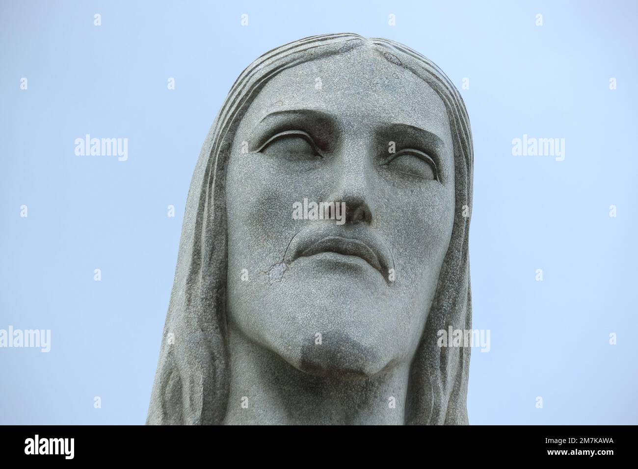 Close up Jesus Statue face or Cristo Redentor head portrait in Rio De Janeiro. Selective focus. Open space area. Stock Photo