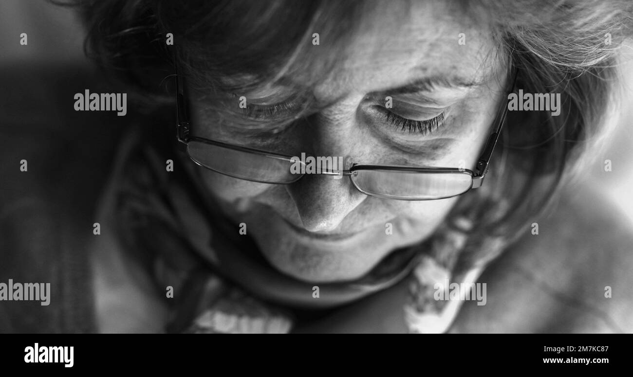 Black and white Close-up of older woman wearing reading glasses Stock Photo