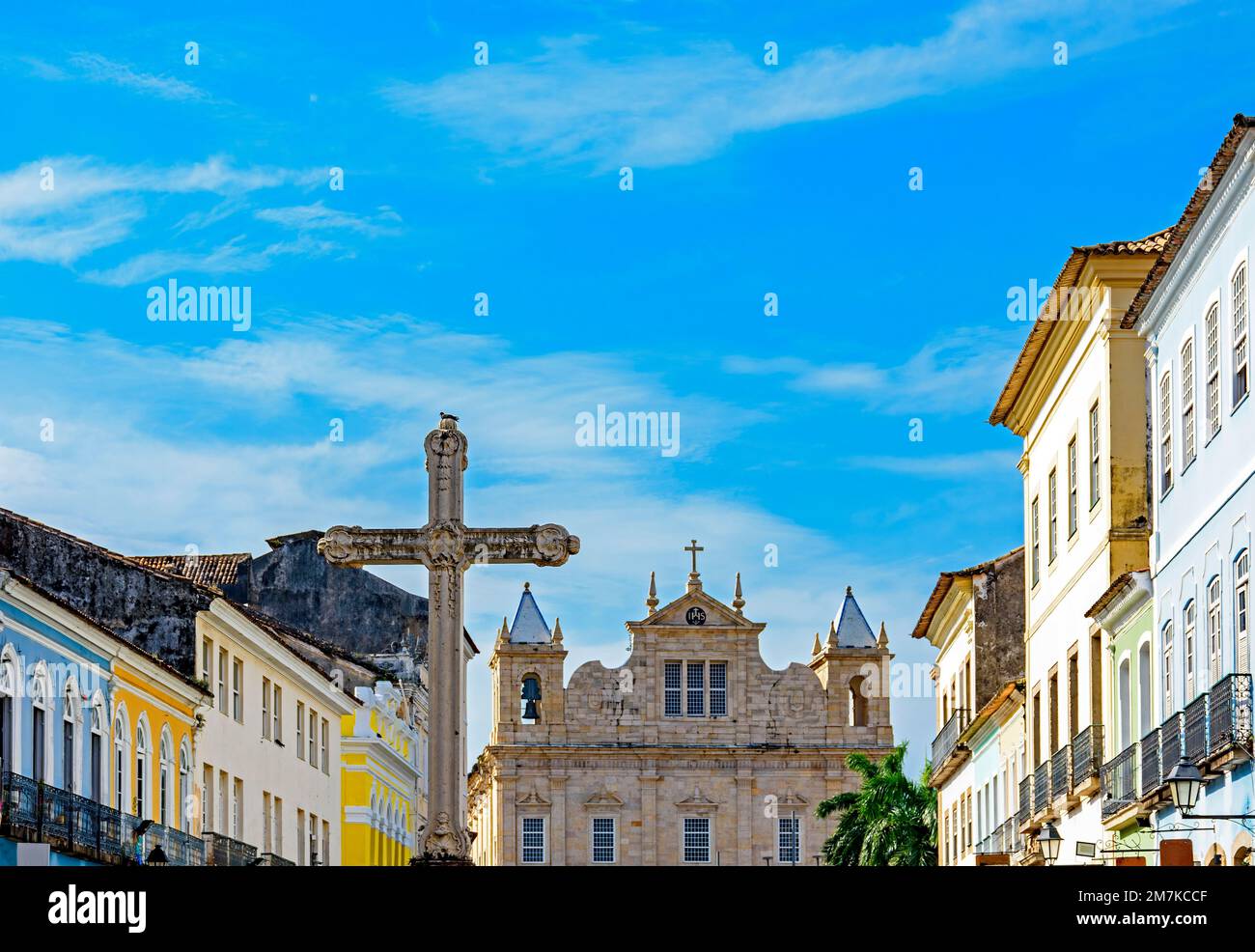 Large crucifix in the central square of the historic district of Pelourinho in the city of Salvador in Bahia with baroque church and colonial houses i Stock Photo