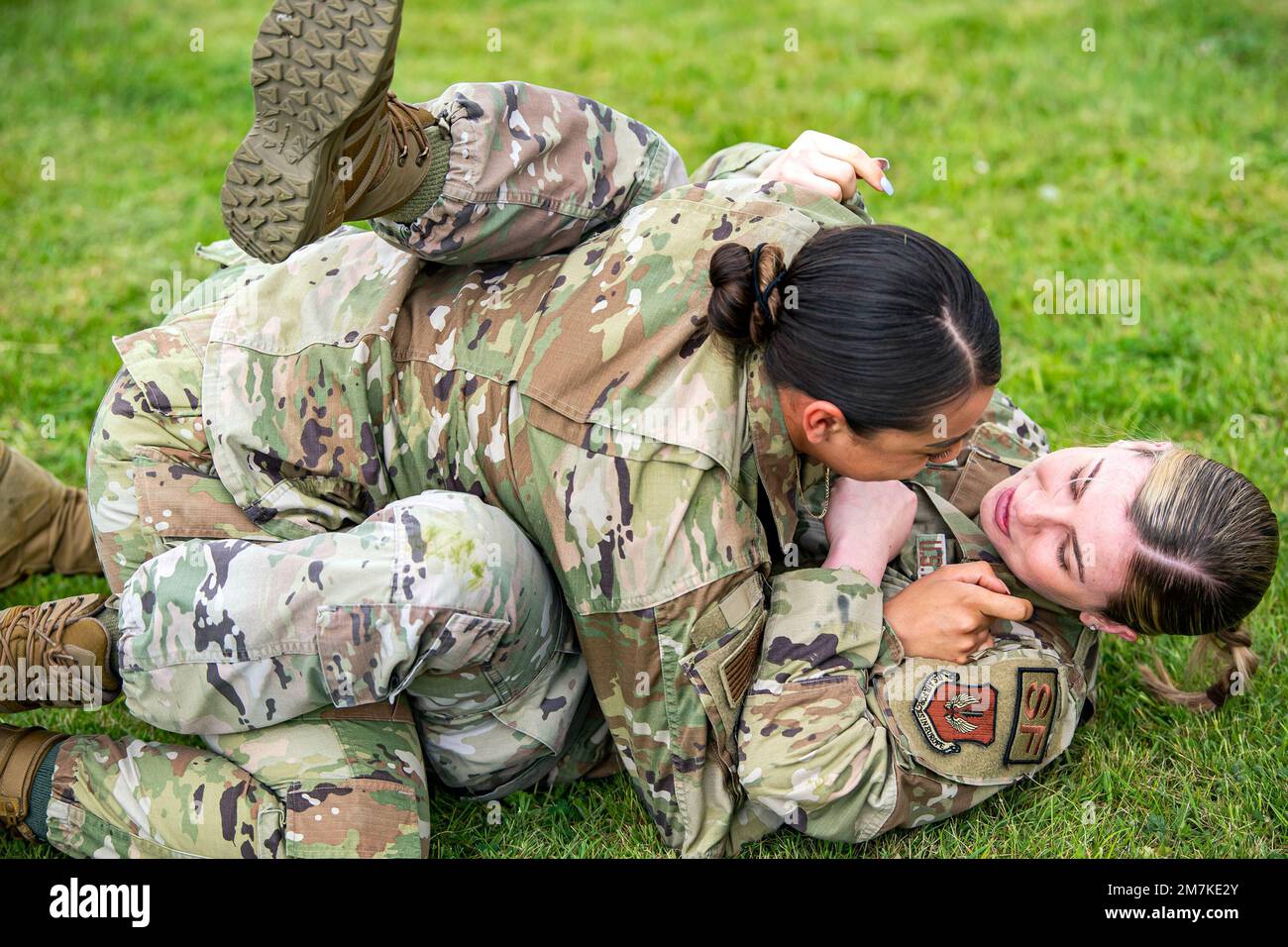 Airman 1st Class Helen Lopez, left, 423d Security Forces Squadron installation patrolman, and Airman 1st Class Sierra Capobianco, base defense operations center controller, demonstrate grappling at RAF Molesworth, England, May 10, 2022. The 423d SFS taught students from Huntingdon’s St. Peter’s school about weapons safety and self defense techniques as part of a mentorship program aimed at strengthening the relationship between the 501st Combat Support Wing and local community. Stock Photo