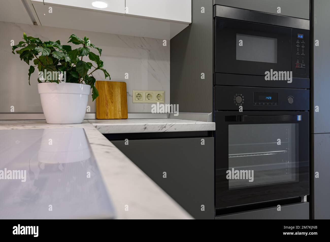 Marble worktop of modern white and dark grey kitchen Stock Photo Alamy