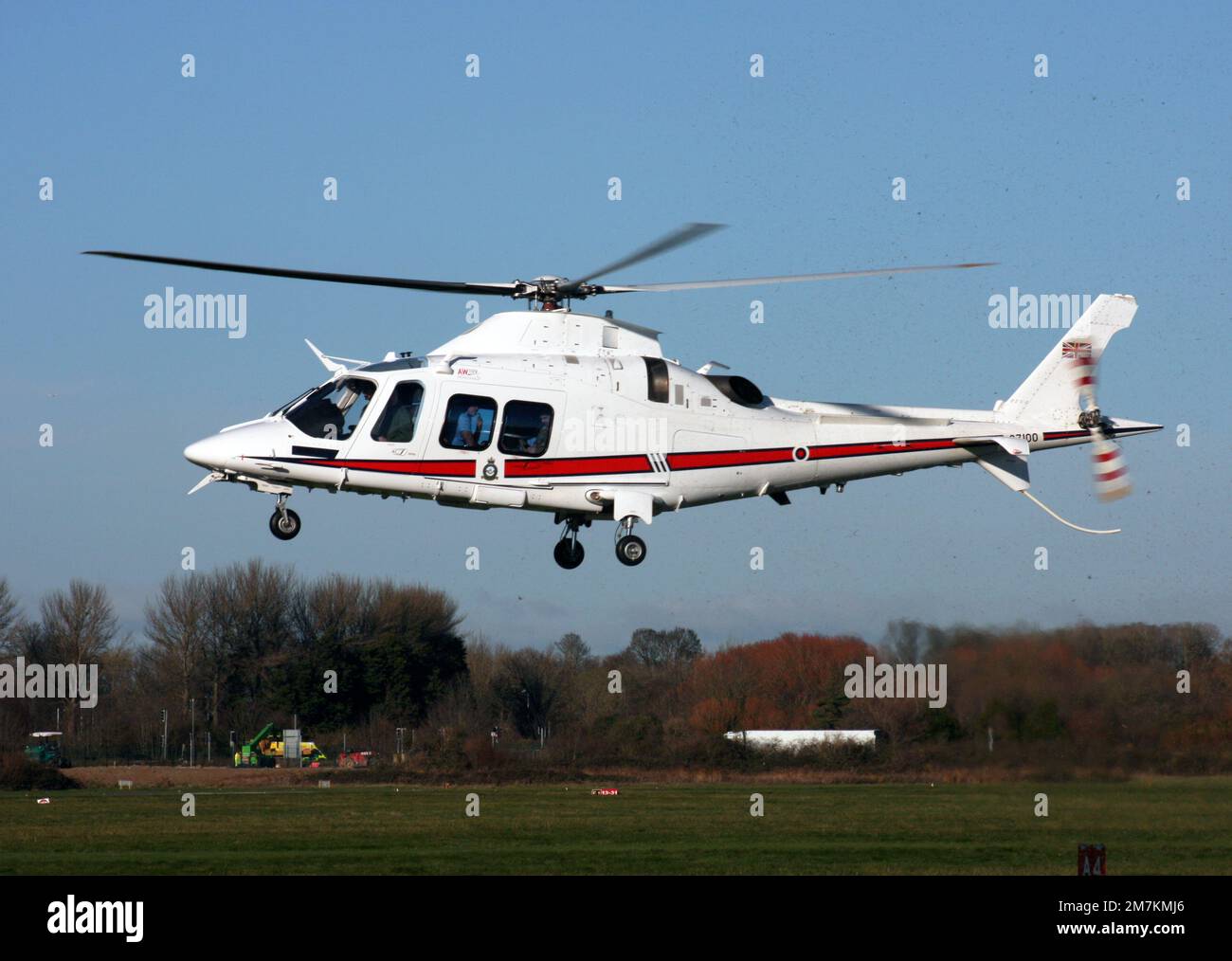 Agusta A109E Power helicopter, GZ100 of RAF 32 Squadron departs