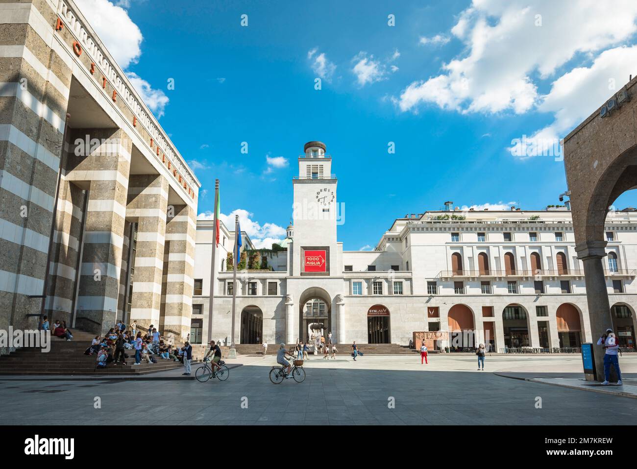 View of the Post Office (left) and buildings flanking the east side of the monumental Italian fascist Piazza della Vittoria (1932), Brescia Italy Stock Photo