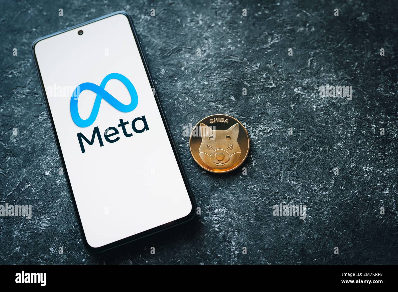 Shiba Inu crypto coin and Meta logo on phone screen. SHIB token and the Metaverse. MSHIBA or Meta Shiba cryptocurrency. Swansea, UK - January 3, 2023. Stock Photo