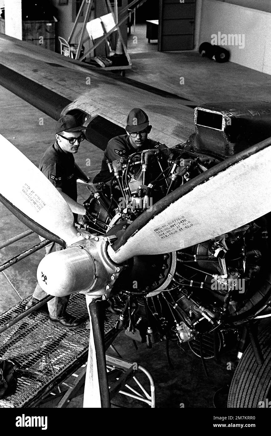Maintaining and repairing delicate flight instruments in the engines of a combat aircraft is the work of A1C Kenneth W. Trossn, left, and George C. Wolf. Both airmen are instrument repairman specialists from the 17th Air Commando Wing. Base: Nha Trang Air Base Country: Viet Nam (VNM) Stock Photo