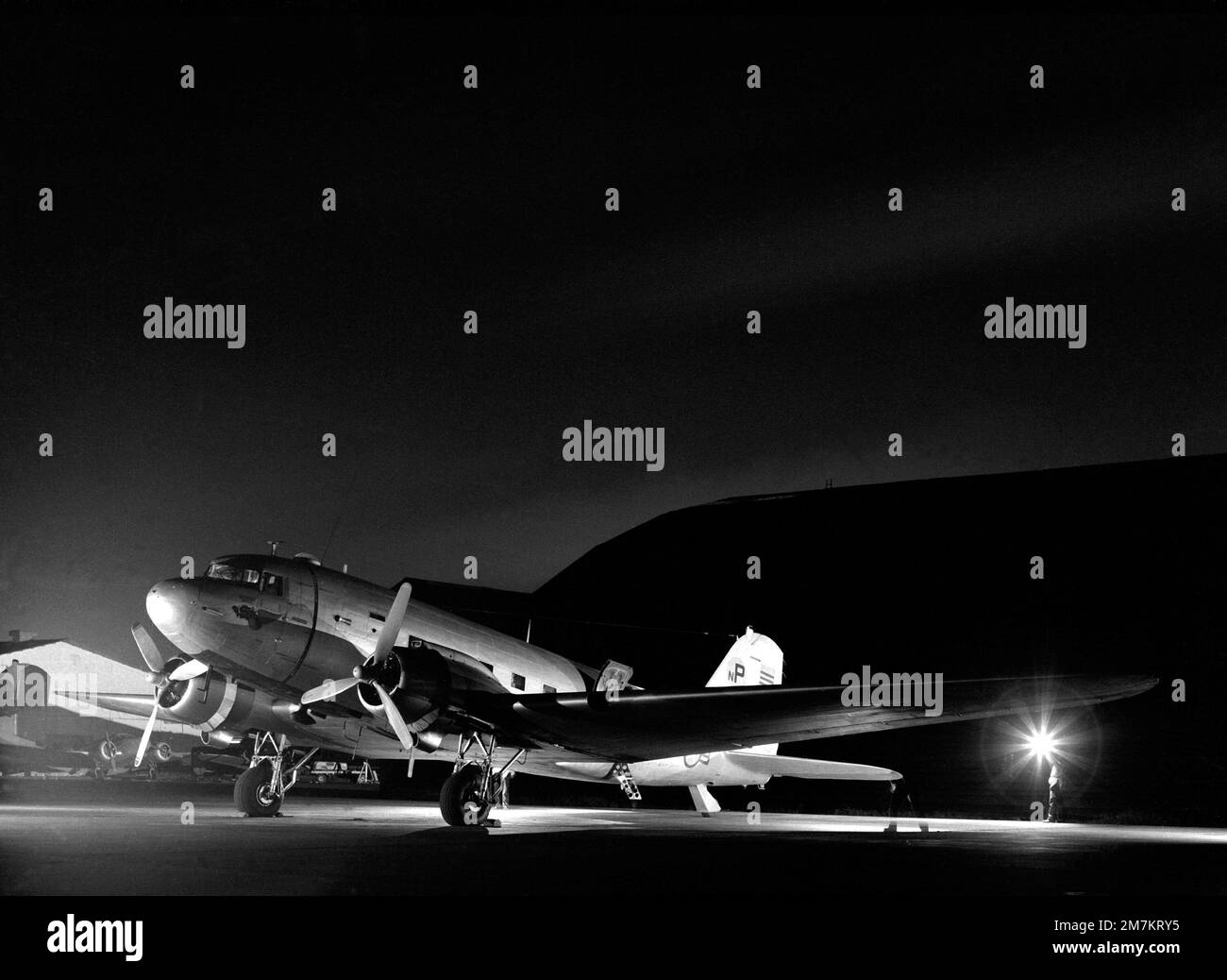 A fullyloaded C47 Skytrain aircraft is poised on the flight line