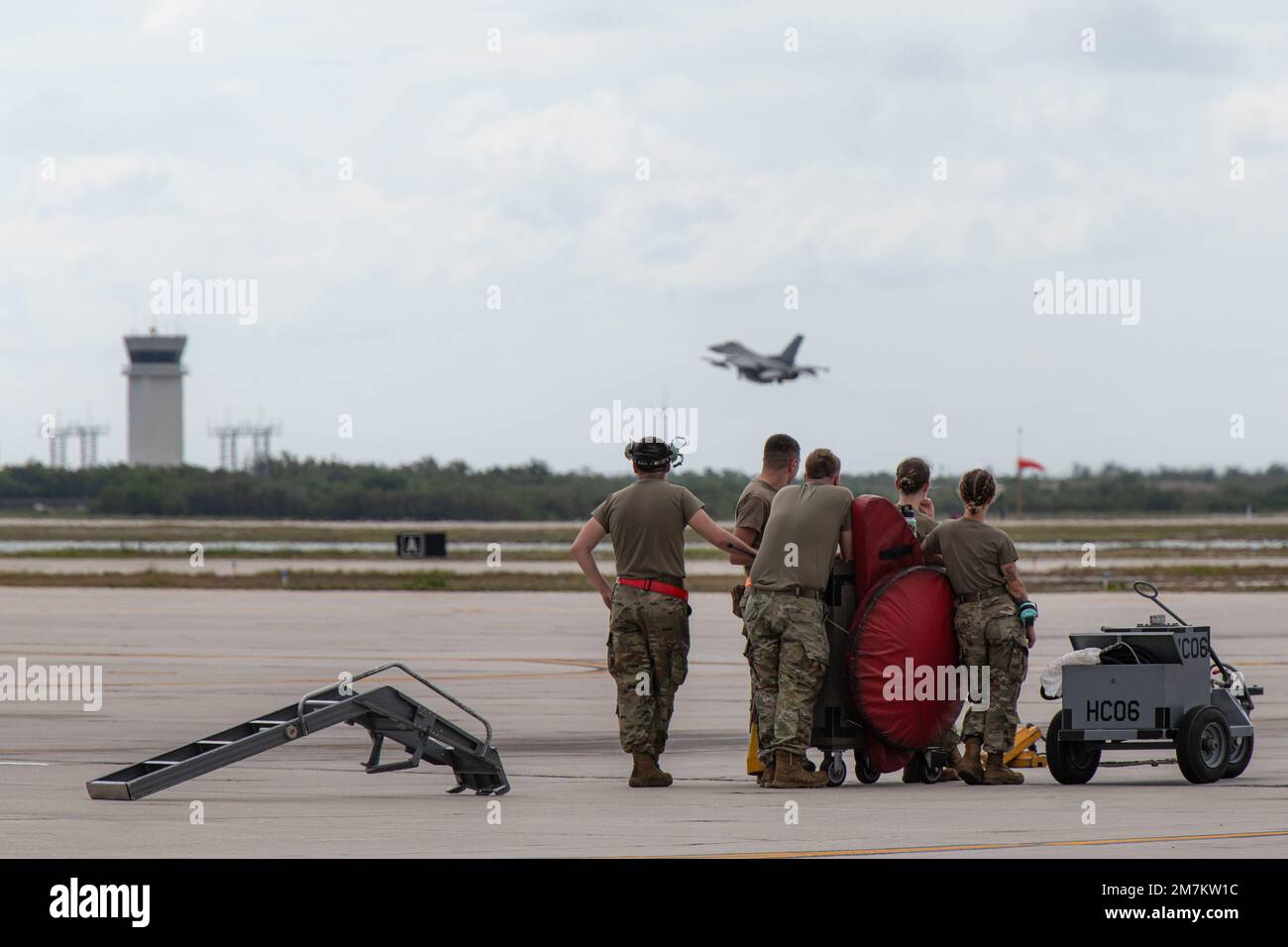 Tactical aircraft maintenance specialists assigned to the Wisconsin Air National Guard's 115th Fighter in Madison, Wisconsin and its co-located active duty counterpart the 378th Fighter Squadron watch an F-16 Fighting Falcon takeoff from the flight line of Naval Air Station Key West May 10, 2022. Approximately 150 Airmen from the 115th FW and its co-located active duty counterpart, the 378th Fighter Squadron, were at NAS Key West participating in dissimilar air combat training with the U.S. Navy, Arizona Air National Guard and Royal Netherlands Air Force. Stock Photo