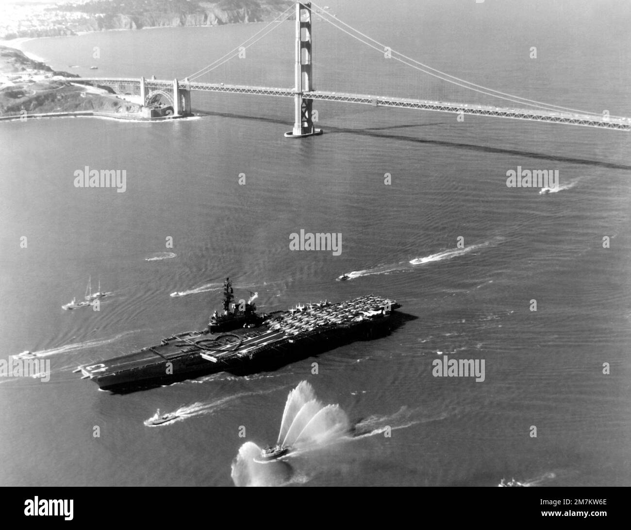 a-harbor-tug-sprays-water-to-welcome-the-aircraft-carrier-uss-coral-sea