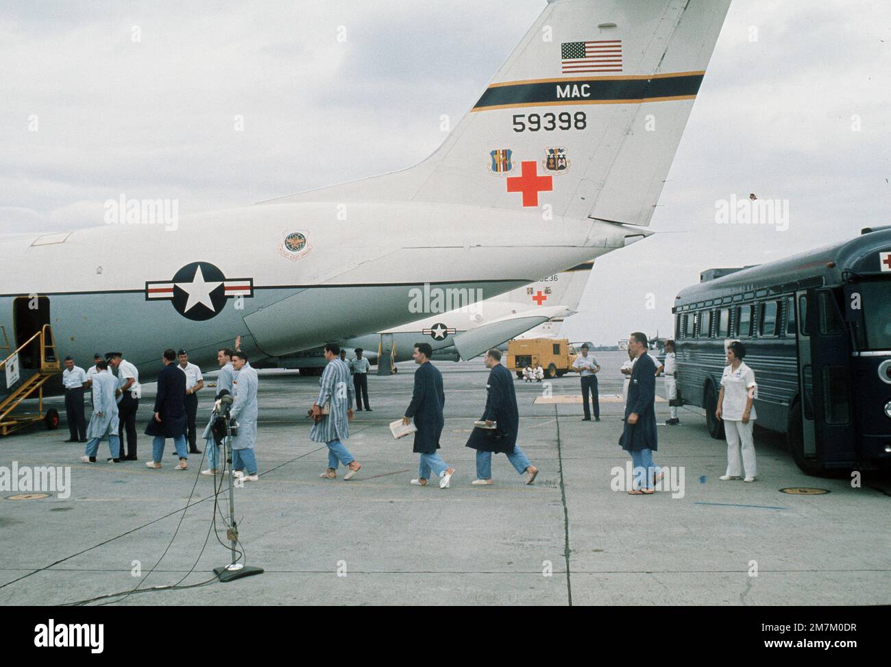 A line of returned POWs from Viet Cong and North Vietnamese prisons walk from buses to the