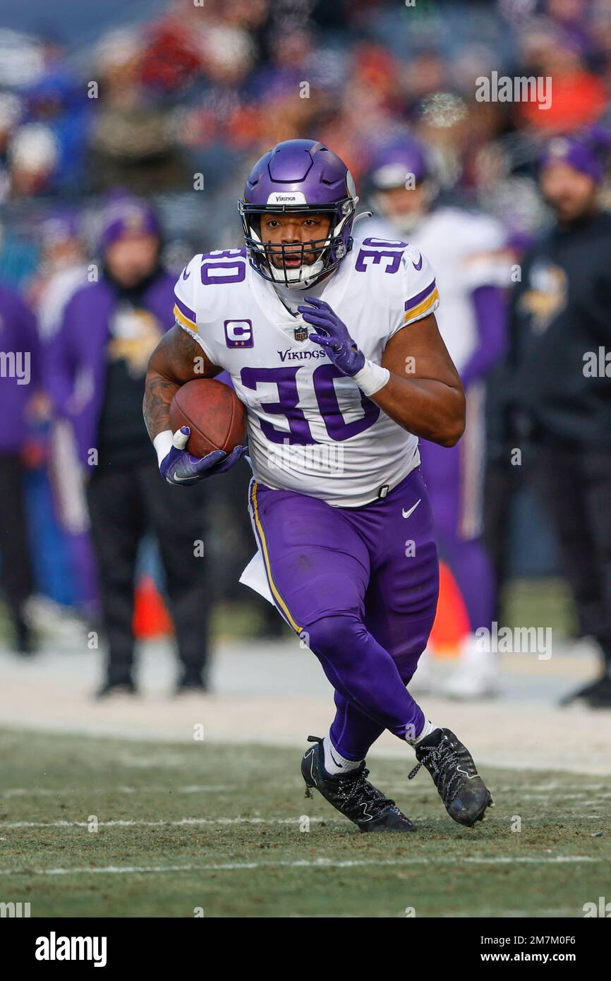 Minnesota Vikings fullback C.J. Ham (30) runs with the ball during the  first half of an NFL football game against the Chicago Bears, Sunday, Jan.  8, 2023, in Chicago. (AP Photo/Kamil Krzaczynski