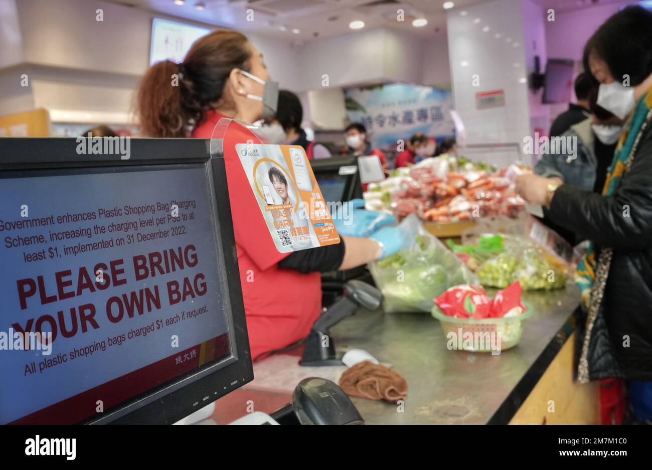 Customers take plastic bags in a supermarket. The government increases