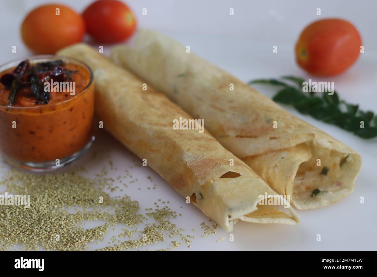Thin crispy Indian crepe made of brown top millet and lentils. A healthy gluten free fermented breakfast dish with millet, called millet ghee roast do Stock Photo