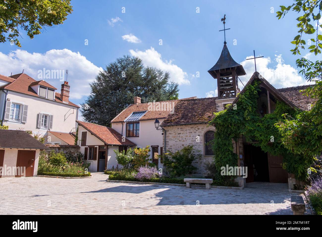 Barbizon (Paris area): ÒGrande RueÓ, main street of the village where numerous post-Impressionist painters used to live, the Chapel and the Theodore R Stock Photo