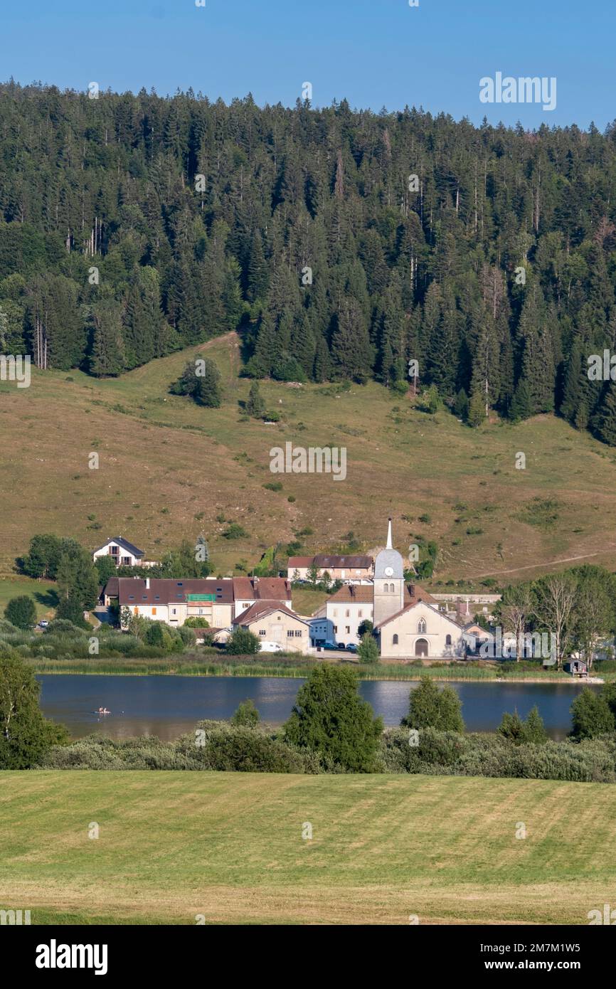 Grande-Riviere Chateau (central-eastern France): overview of the lake of the abbey with the Grandvaux Abbey and the countryside of the upper part of t Stock Photo
